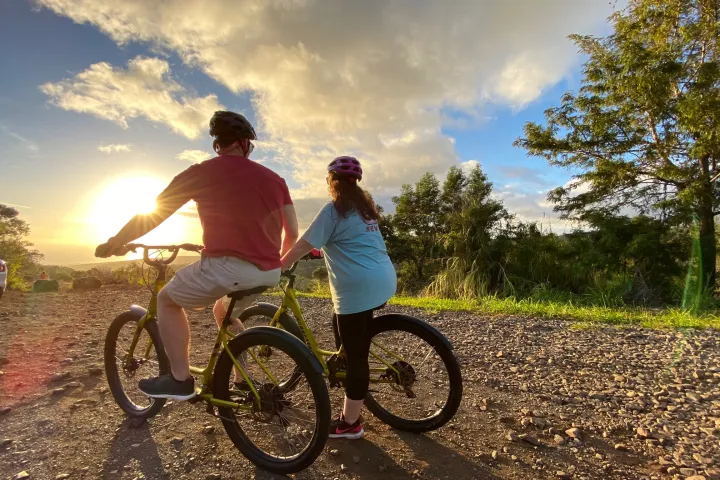 a man riding a bike down a dirt road