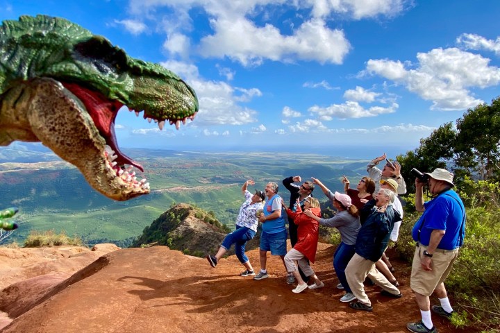 a group of people standing on top of a dirt field