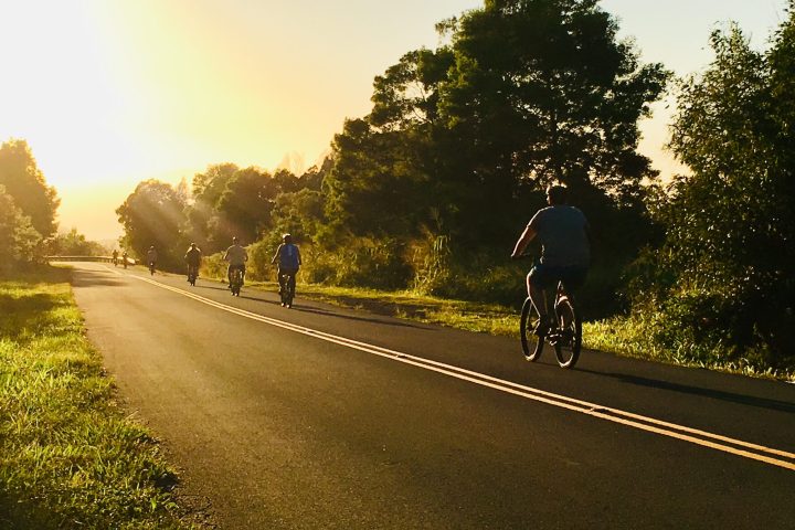 a man riding a motorcycle down a dirt road