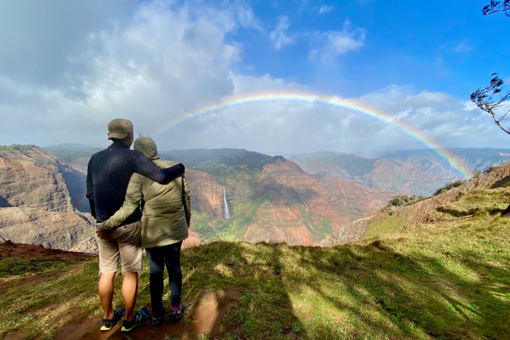 a group of people standing on top of a mountain