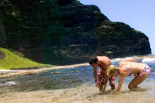 a person standing next to a body of water