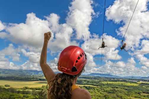 a man flying through the air on a cloudy day