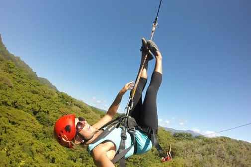 a person holding up a mountain in the background