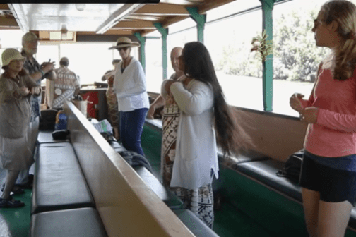 a group of people learning to do the hula.