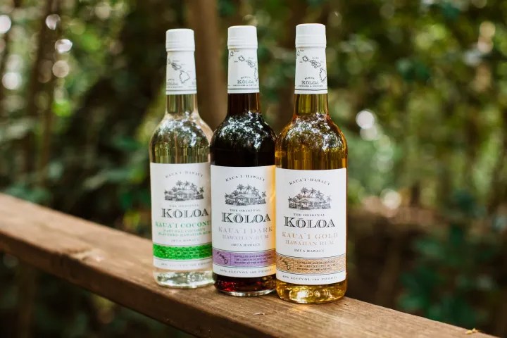 close up of a bottle of wine sitting on top of a wooden table