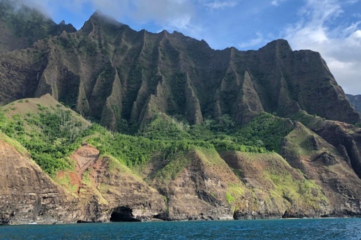a large body of water with a mountain in the background