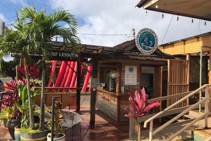a group of people sitting at a table in front of a building