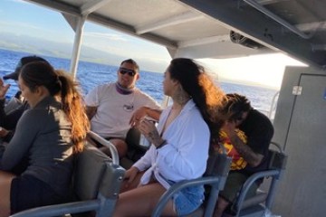 a group of people sitting around a plane