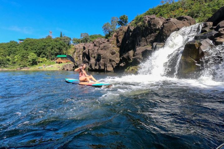 a waterfall going over a body of water