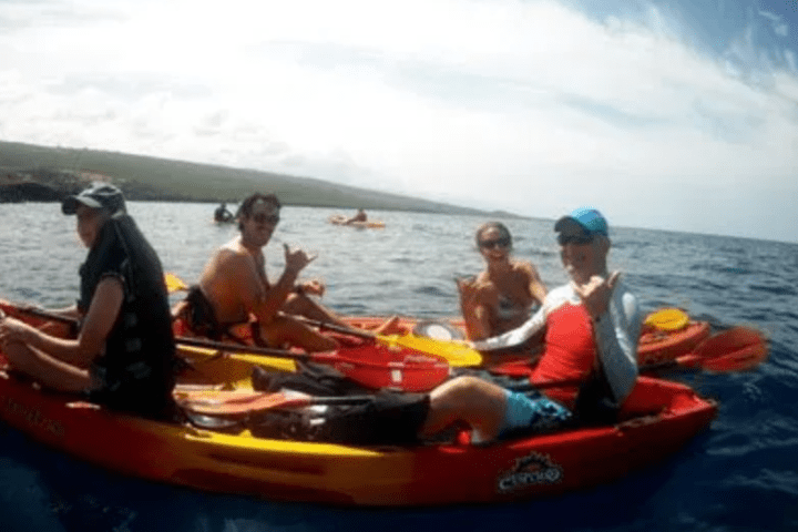 a group of people riding on the back of a boat