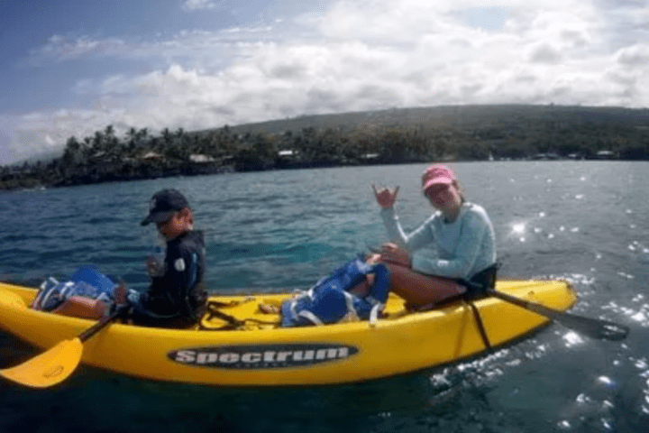 a group of people riding on the back of a boat in the water