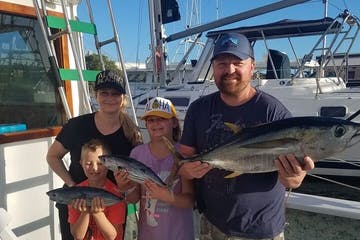 a man holding a fish on a boat