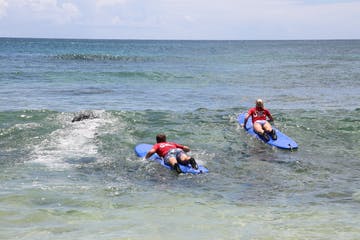 a group of people surfing in the ocean