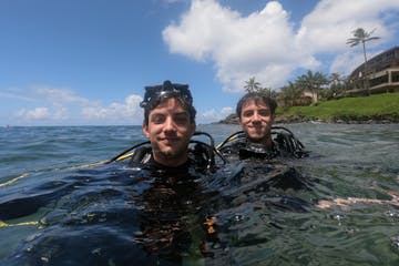 a man standing next to a body of water