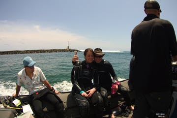 a group of people standing next to a body of water