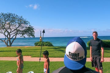 a group of people standing on top of a grass covered field