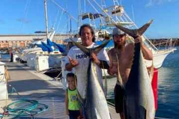 a person holding a fish in the water