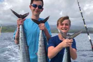a man holding a fish in the water
