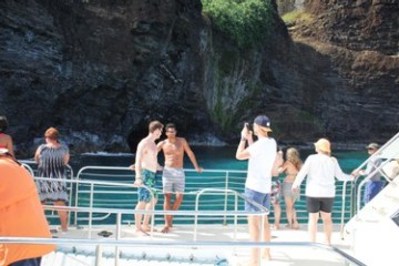 a group of people standing next to a fence