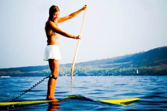 a person standing next to a body of water