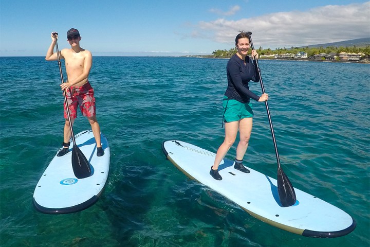 a man standing next to a body of water