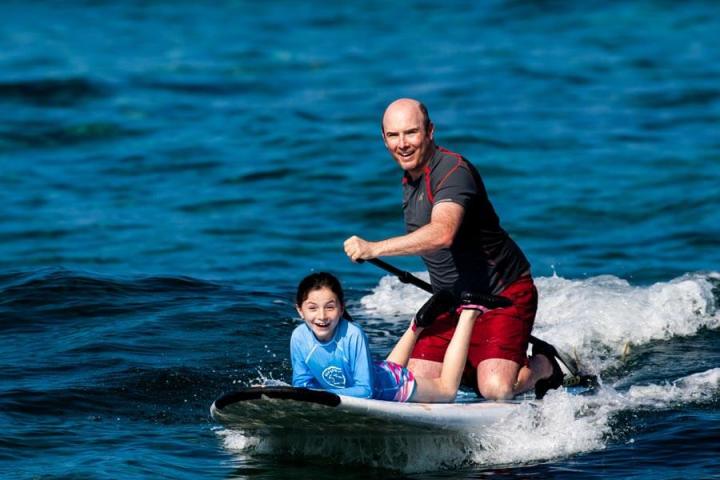 a person riding a surf board on a body of water