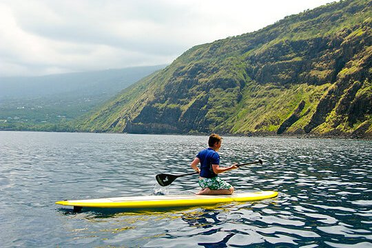 a person riding a surf board on a body of water