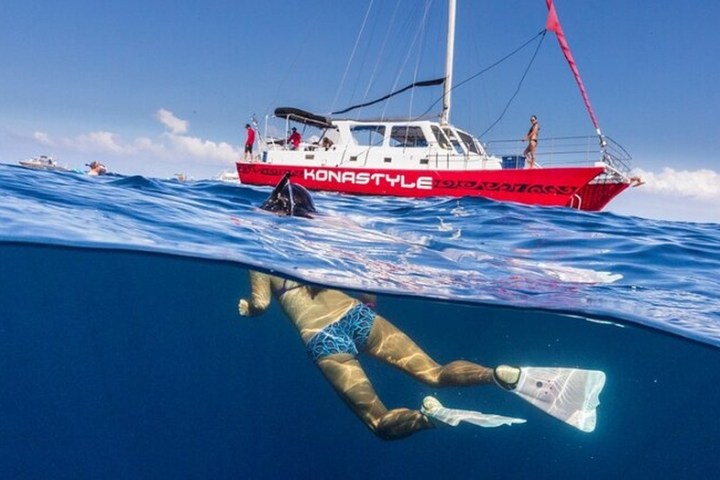 a man riding on the back of a boat in a body of water