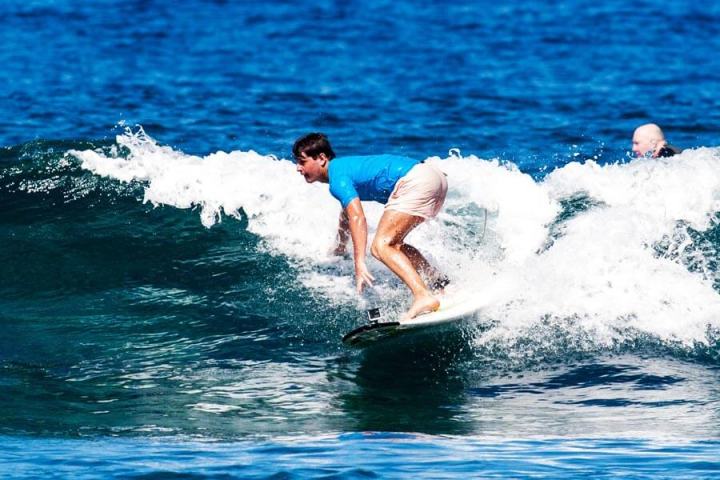 a girl riding a wave on a surfboard in the ocean