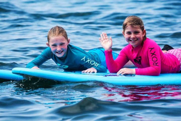 a young boy swimming in a body of water