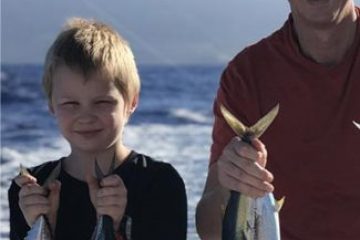 a person holding a fish in the water