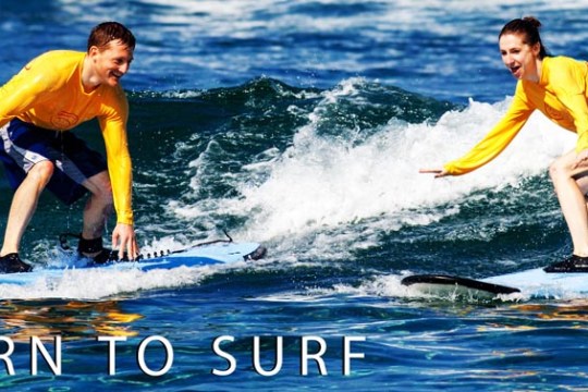 a young girl riding a wave on a surfboard in the water