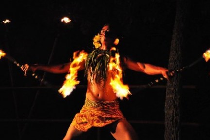 a man standing in front of a fire