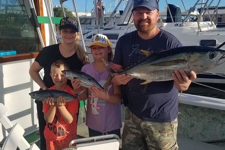 a couple of people that are standing in front of a boat