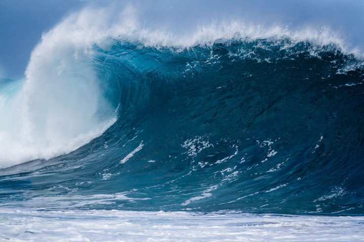 a man riding a wave on a surfboard in the water