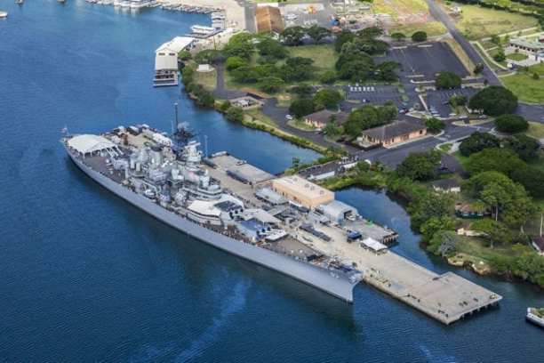 a body of water with a city in the background