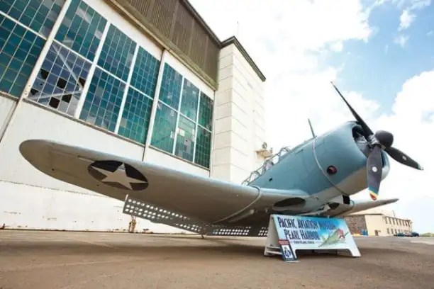 a small airplane is parked on the side of a building