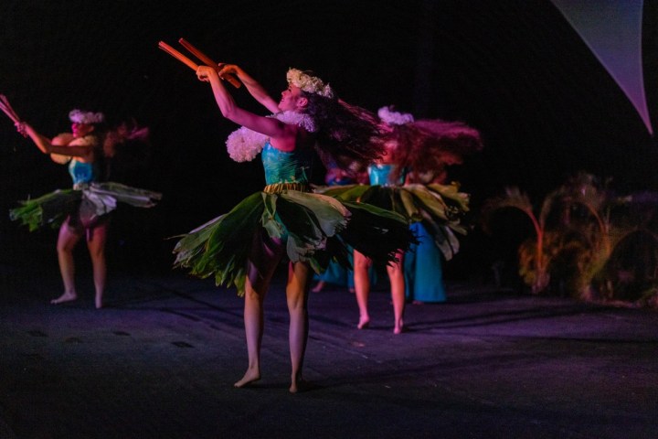 a little girl that is lit up at night