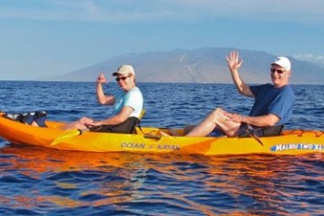 a man riding on the back of a boat in a body of water