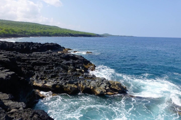 a rocky shore next to a body of water