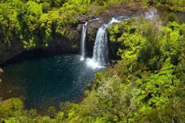 a large waterfall in a forest