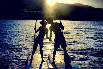 a man standing next to a body of water