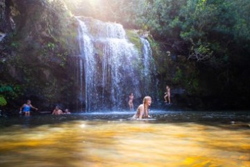 a person standing next to a waterfall