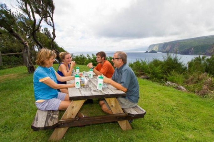 a person sitting at a picnic table