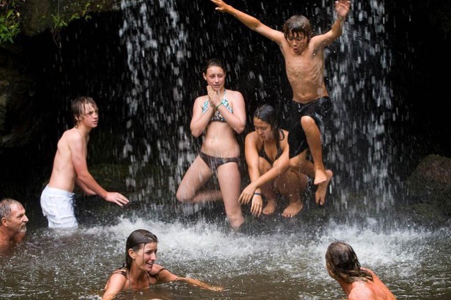 a group of people swimming in a pool of water