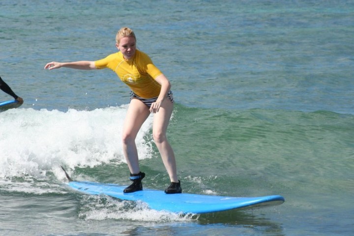a person riding a wave on a surfboard in the ocean