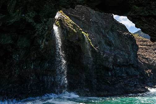 a large waterfall over a rocky cliff