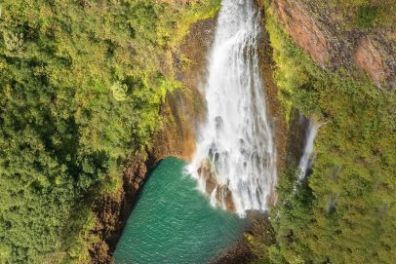 a waterfall with trees in the background