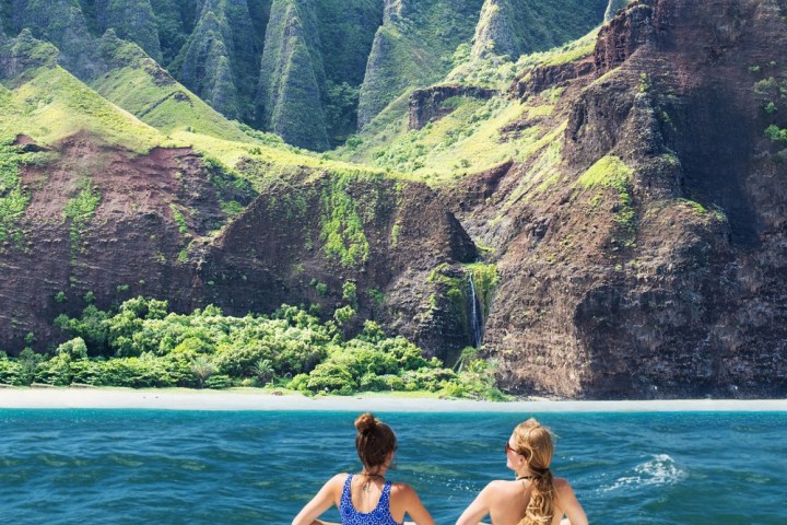 a group of people standing in front of a mountain
