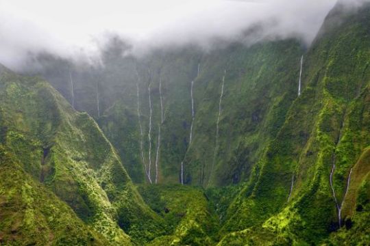 a waterfall with a mountain in the background